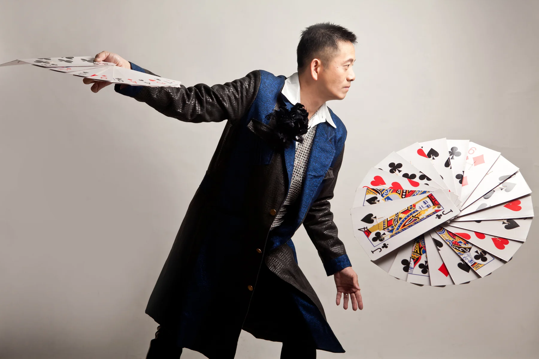 magicSam performing with fans of playing cards.