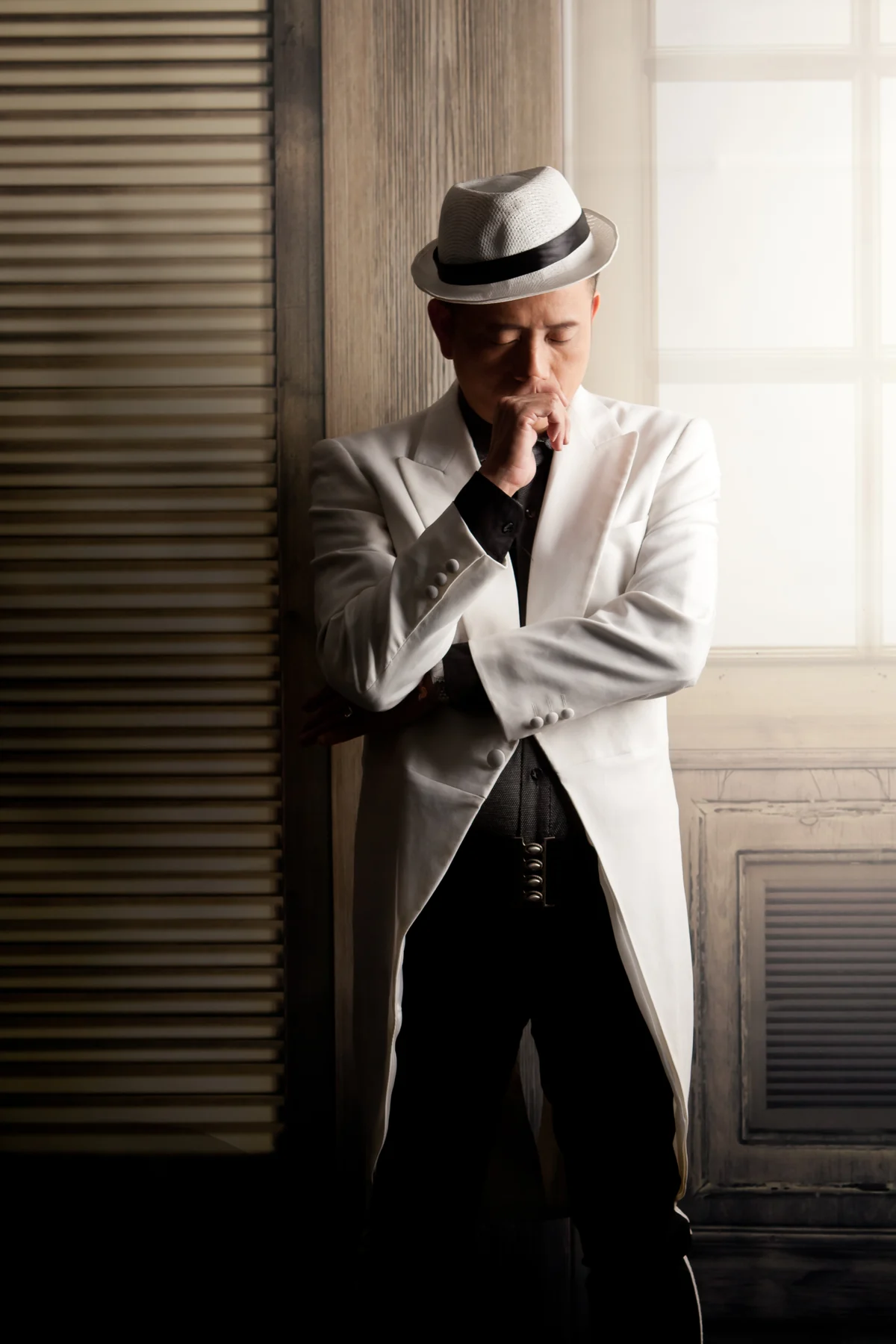 Portrait of magicSam in a white jacket and hat.